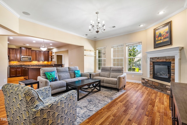2129 Glade Valley Ln, Morrisville, NC 27560 - living area with wood finished floors, a chandelier, crown molding, a fireplace, and recessed lighting