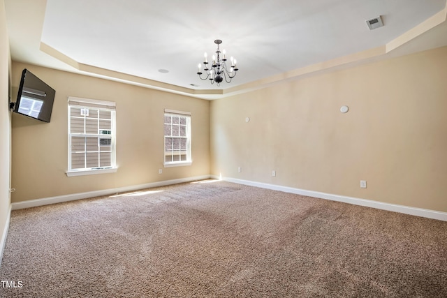 2129 Glade Valley Ln, Morrisville, NC 27560 - carpeted empty room with a tray ceiling and a chandelier