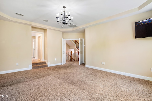 2129 Glade Valley Ln, Morrisville, NC 27560 - spare room with a chandelier, carpet floors, and a tray ceiling