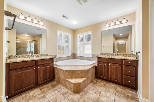 2129 Glade Valley Ln, Morrisville, NC 27560 - bathroom featuring a stall shower, two vanities, and a garden tub