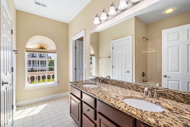2129 Glade Valley Ln, Morrisville, NC 27560 - bathroom featuring double vanity, tile patterned floors, and washtub / shower combination