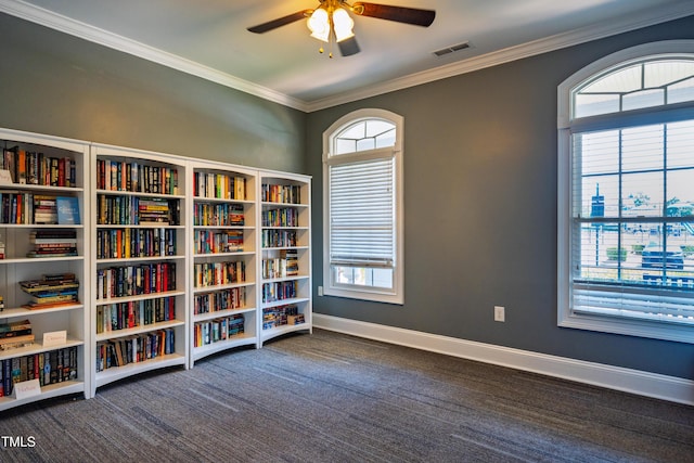 2129 Glade Valley Ln, Morrisville, NC 27560 - sitting room featuring a ceiling fan, ornamental molding, carpet floors, bookshelves, and healthy amount of natural light