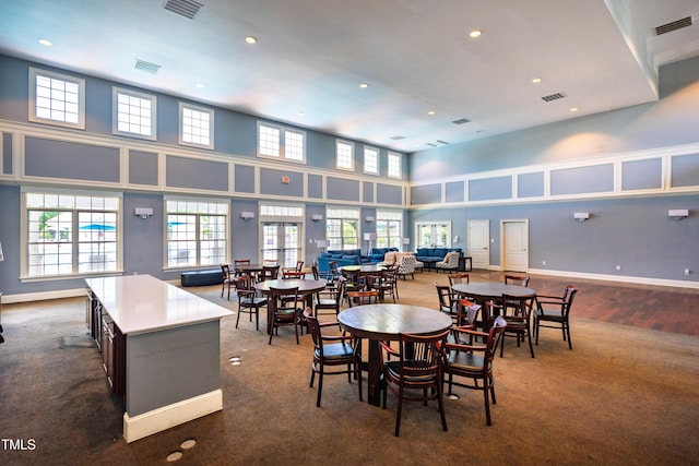 2129 Glade Valley Ln, Morrisville, NC 27560 - dining area featuring recessed lighting, healthy amount of natural light, a high ceiling, and dark colored carpet