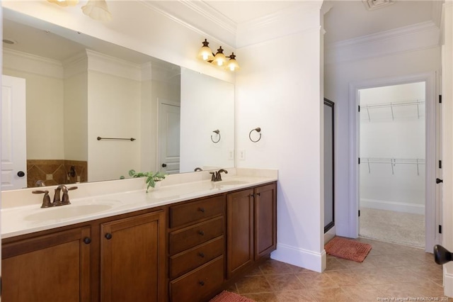 3310 Starboard Way Unit 301, Fayetteville, NC 28314 - bathroom featuring crown molding, a shower stall, double vanity, a walk in closet, and tile patterned flooring