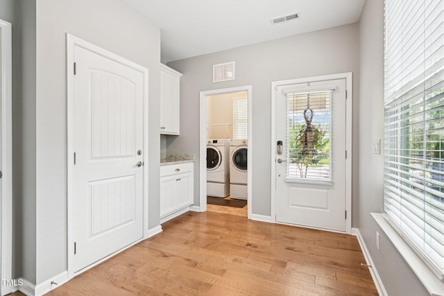 833 Atticus Way, Durham, NC 27703 - laundry room featuring washer and dryer, light wood-type flooring, and healthy amount of natural light