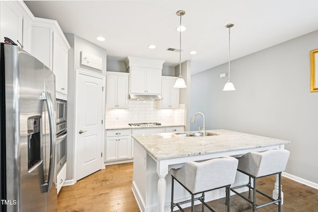 833 Atticus Way, Durham, NC 27703 - kitchen featuring appliances with stainless steel finishes, light wood finished floors, tasteful backsplash, white cabinets, and recessed lighting