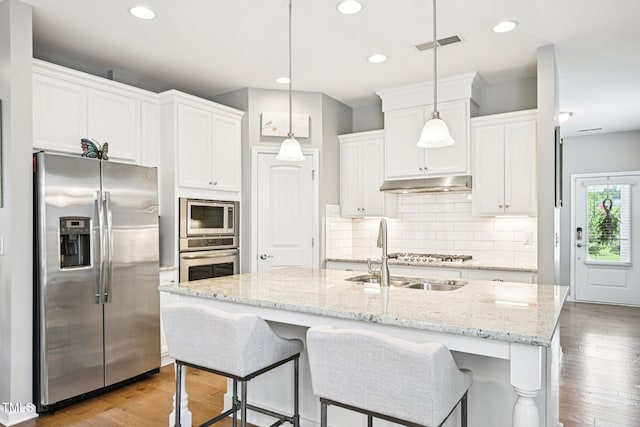 833 Atticus Way, Durham, NC 27703 - kitchen featuring appliances with stainless steel finishes, under cabinet range hood, white cabinetry, decorative backsplash, and recessed lighting