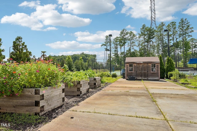 833 Atticus Way, Durham, NC 27703 - view of patio with a garden, a storage shed, and driveway