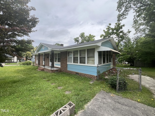 503 Adams St, Henderson, NC 27536 - view of property exterior featuring a sunroom, covered porch, and crawl space