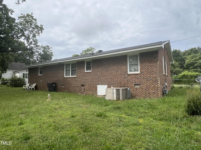 503 Adams St, Henderson, NC 27536 - rear view of house featuring brick siding, a lawn, and crawl space