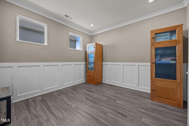 22 Combine Trl, Benson, NC 27504 - unfurnished room with crown molding, a decorative wall, dark wood-style floors, recessed lighting, and wainscoting