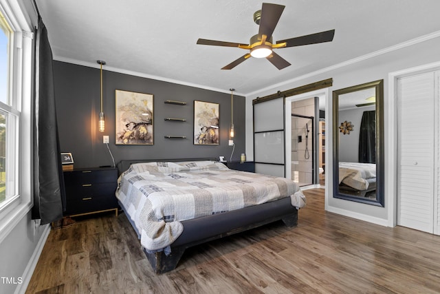 10 Wilders Ln, Louisburg, NC 27549 - bedroom featuring wood finished floors, ornamental molding, a barn door, and a ceiling fan
