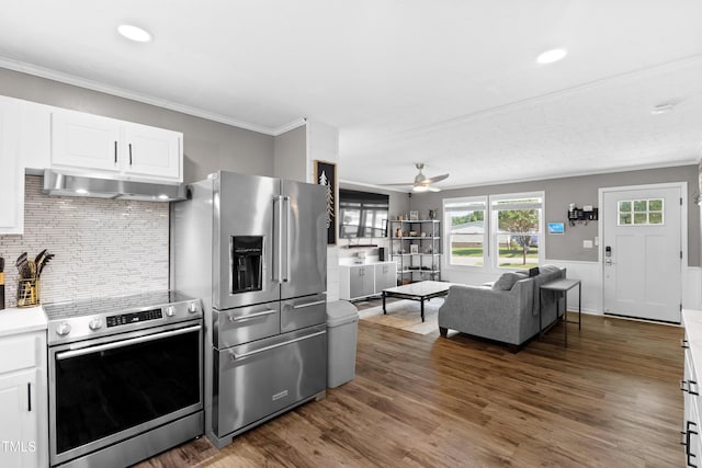 10 Wilders Ln, Louisburg, NC 27549 - kitchen with appliances with stainless steel finishes, under cabinet range hood, dark wood-style floors, tasteful backsplash, and crown molding