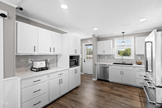 10 Wilders Ln, Louisburg, NC 27549 - kitchen with stainless steel appliances, tasteful backsplash, white cabinetry, recessed lighting, and ornamental molding