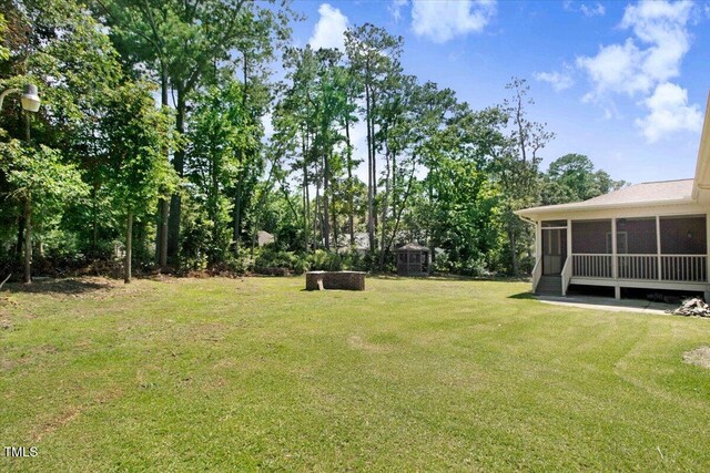 206 Tramway Pl, Goldsboro, NC 27534 - view of grassy yard featuring a sunroom and a storage shed