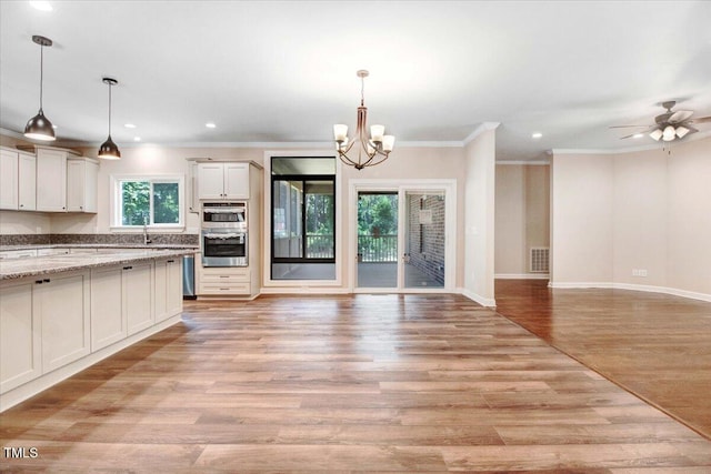 206 Tramway Pl, Goldsboro, NC 27534 - kitchen featuring open floor plan, a chandelier, crown molding, light wood-style flooring, and recessed lighting