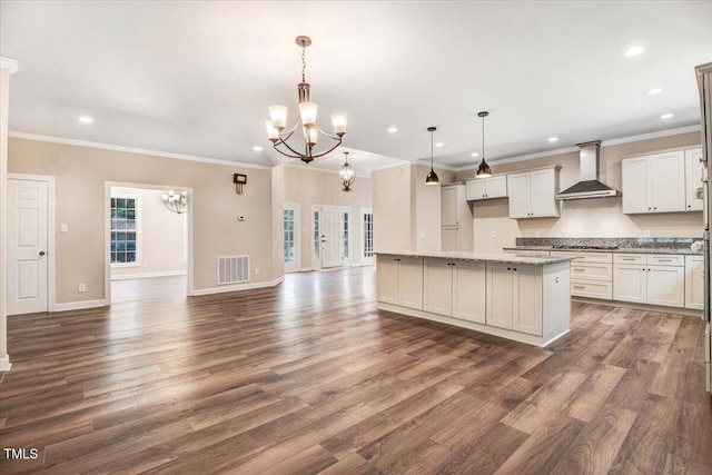 206 Tramway Pl, Goldsboro, NC 27534 - kitchen featuring wall chimney range hood, a chandelier, ornamental molding, gas stovetop, and dark wood-style floors