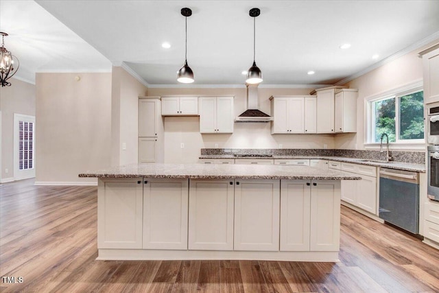 206 Tramway Pl, Goldsboro, NC 27534 - kitchen with appliances with stainless steel finishes, crown molding, a kitchen island, light stone counters, and light wood-type flooring