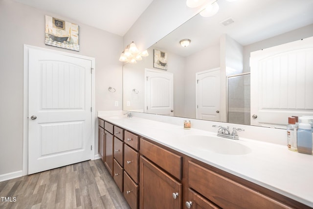 614 Marian Way, Sanford, NC 27330 - bathroom featuring double vanity, wood finished floors, and a tile shower