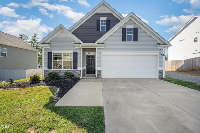614 Marian Way, Sanford, NC 27330 - view of front of property featuring stone siding, concrete driveway, and an attached garage