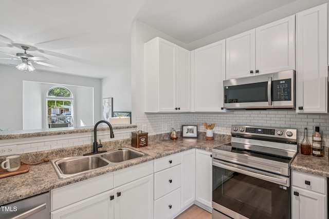 3973 Volkswalk Pl, Raleigh, NC 27610 - kitchen featuring stainless steel appliances, ceiling fan, backsplash, and white cabinets