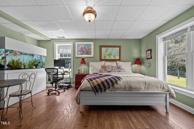 3511 Corbett Rd, Mebane, NC 27302 - bedroom featuring multiple windows, a drop ceiling, wood finished floors, and an office area