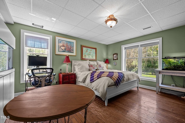 3511 Corbett Rd, Mebane, NC 27302 - bedroom featuring a drop ceiling, multiple windows, and wood finished floors