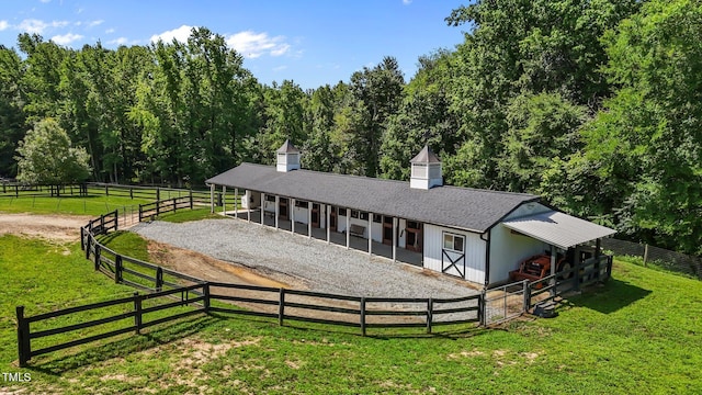 3511 Corbett Rd, Mebane, NC 27302 - back of property with an exterior structure, an outbuilding, driveway, a shingled roof, and a view of rural / pastoral area