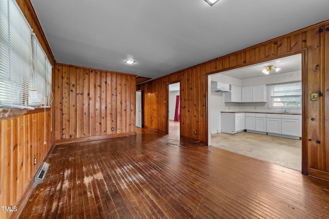 2512 Mckinney St, Burlington, NC 27217 - unfurnished living room with wooden walls and hardwood / wood-style flooring