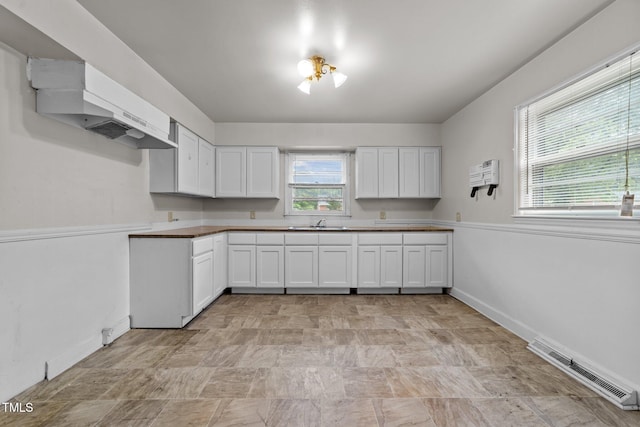 2512 Mckinney St, Burlington, NC 27217 - kitchen featuring white cabinetry and extractor fan