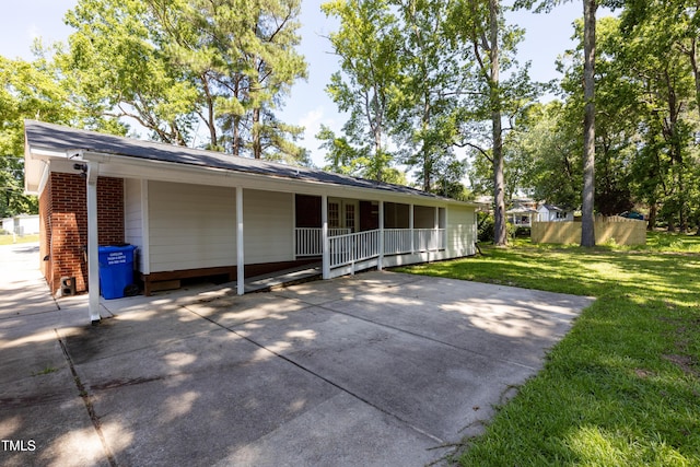 438 N Hickory St, Angier, NC 27501 - rear view of property featuring a yard, brick siding, and covered porch