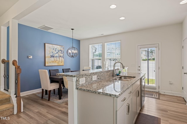 1137 Amber Shadow Dr, Durham, NC 27703 - kitchen featuring light wood finished floors, plenty of natural light, recessed lighting, hanging light fixtures, and a chandelier