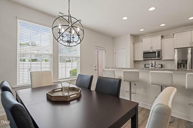 1137 Amber Shadow Dr, Durham, NC 27703 - dining room with a chandelier, wood finished floors, and recessed lighting