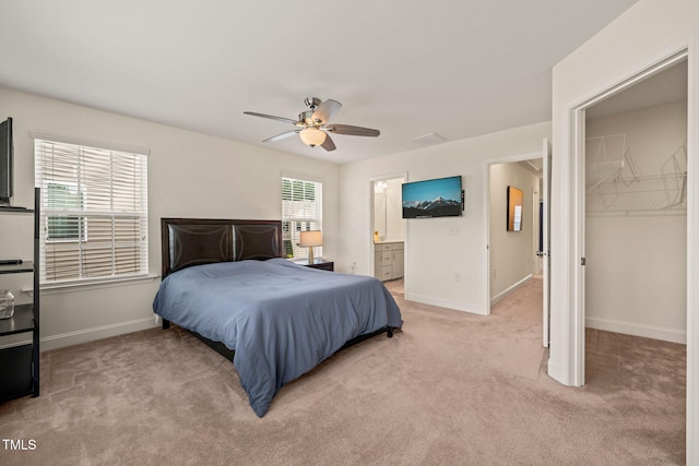 1137 Amber Shadow Dr, Durham, NC 27703 - bedroom with light carpet, ensuite bathroom, a ceiling fan, and a walk in closet
