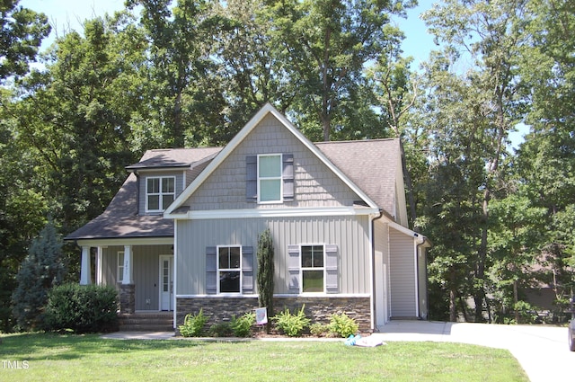 2471 Golden Forest Dr, Franklinton, NC 27525 - craftsman-style home featuring a front yard, a shingled roof, stone siding, and a porch
