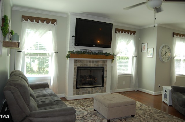 2471 Golden Forest Dr, Franklinton, NC 27525 - living room featuring a ceiling fan, wood finished floors, a tile fireplace, and ornamental molding
