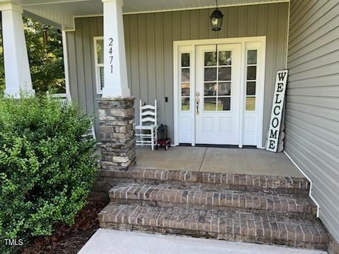 2471 Golden Forest Dr, Franklinton, NC 27525 - property entrance featuring covered porch and board and batten siding