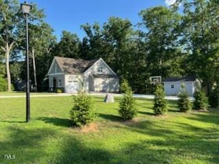 2471 Golden Forest Dr, Franklinton, NC 27525 - view of green lawn featuring an outdoor structure and a garage