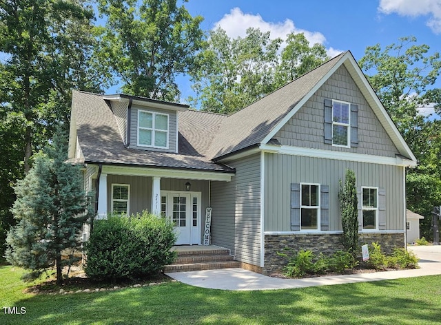 2471 Golden Forest Dr, Franklinton, NC 27525 - craftsman-style home featuring board and batten siding, a front yard, a shingled roof, and stone siding