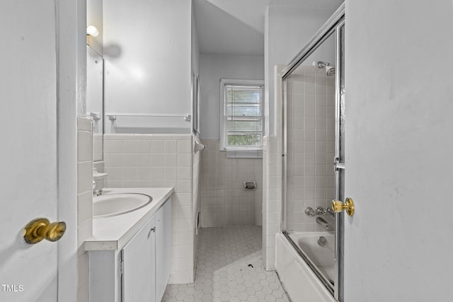 1402 Tarleton Ave, Burlington, NC 27215 - bathroom featuring vanity, tile patterned flooring, combined bath / shower with glass door, tile walls, and wainscoting