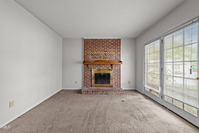 1402 Tarleton Ave, Burlington, NC 27215 - unfurnished living room with a textured ceiling, carpet flooring, plenty of natural light, and a fireplace
