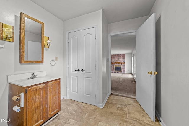 1402 Tarleton Ave, Burlington, NC 27215 - bathroom with vanity and a brick fireplace