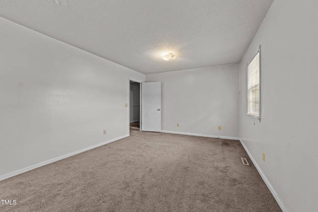 1402 Tarleton Ave, Burlington, NC 27215 - carpeted spare room with a textured ceiling and baseboards