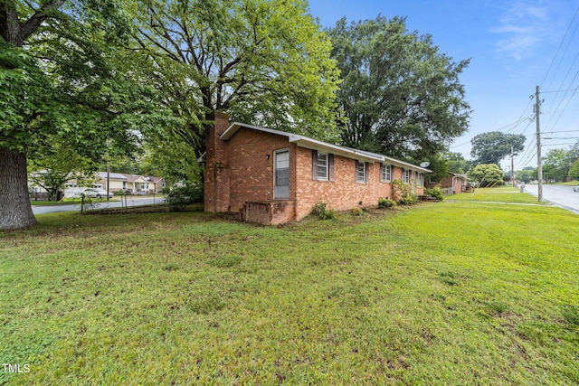 1402 Tarleton Ave, Burlington, NC 27215 - view of side of property with a chimney, a lawn, brick siding, and crawl space