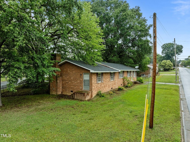 1402 Tarleton Ave, Burlington, NC 27215 - view of side of home with crawl space, a yard, a chimney, and brick siding