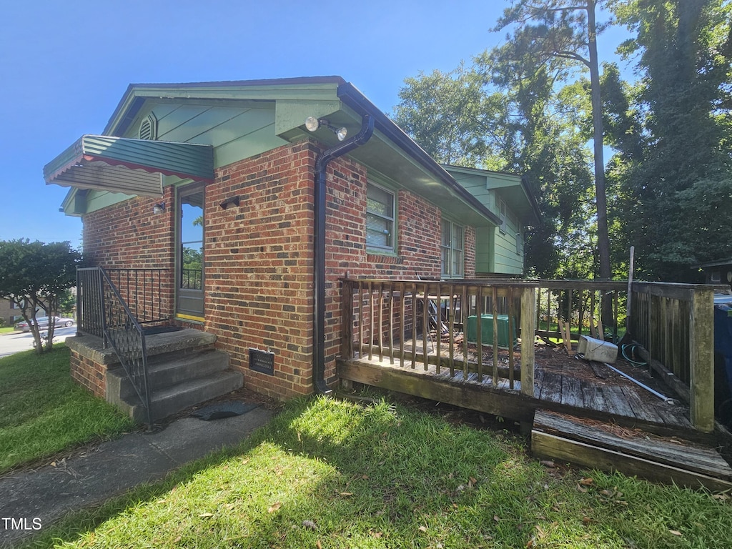 2308 Blacklan Cir, Raleigh, NC 27610 - view of property exterior featuring brick siding and a wooden deck