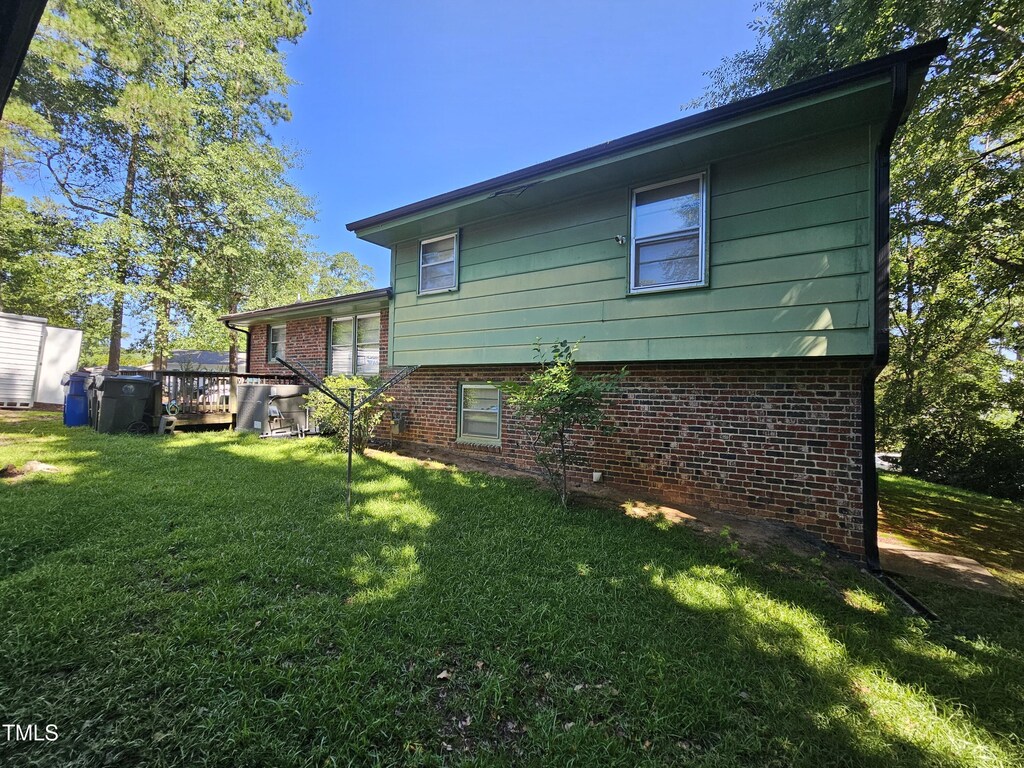 2308 Blacklan Cir, Raleigh, NC 27610 - back of house with brick siding, a yard, and a deck