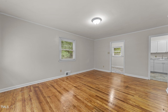 807 New St, Graham, NC 27253 - empty room featuring light wood finished floors and ornamental molding