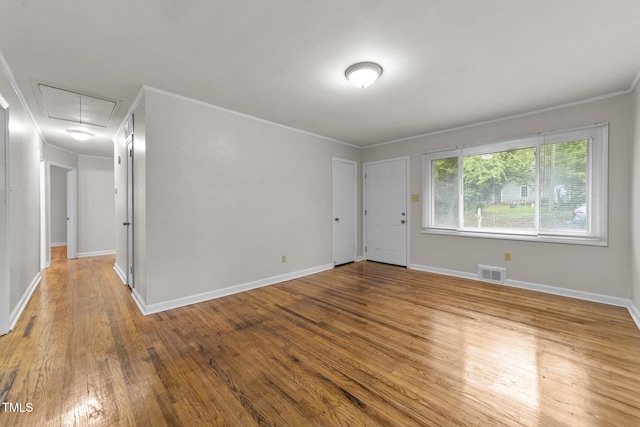 807 New St, Graham, NC 27253 - spare room with attic access, ornamental molding, and wood finished floors