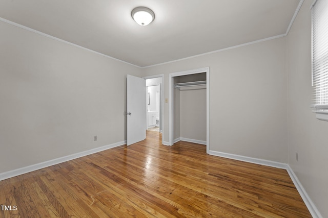 807 New St, Graham, NC 27253 - unfurnished bedroom featuring light wood-style flooring, ornamental molding, and a closet